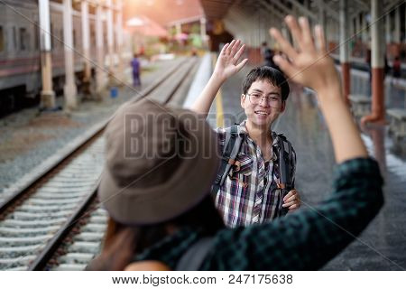 Couple Traveller Say A Good Bye At Train Station With A Traveler.