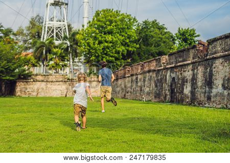 Dad And Son On Background Of Fort Cornwallis In Georgetown, Penang, Is A Star Fort Built By The Brit
