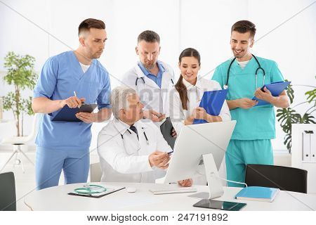 Group Of Doctors Attending Meeting In Clinic. Cardiology Conference