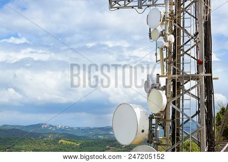 Telecommunication Tower With Antennas Of Cellular Communication And Radar Systems. Against Cloudy Sk