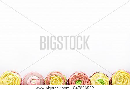 Capcake With Yellow And Pink Cream On A White Background. Isolate.