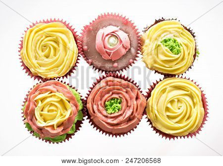 Capcake With Yellow And Pink Cream On A White Background. Isolate.