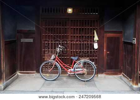 Red Mama Cheri Bicycle In Front Of Japanese Wooden Sliding Door