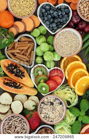 Healthy high fibre dietary food concept with whole wheat pasta, legumes, cereals and grains. High in  antioxidants, anthocyanins, smart carbohydrates and vitamins. Top view.