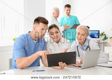 Group Of Doctors Attending Meeting In Clinic. Cardiology Conference