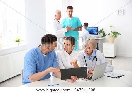 Group Of Doctors Attending Meeting In Clinic. Cardiology Conference