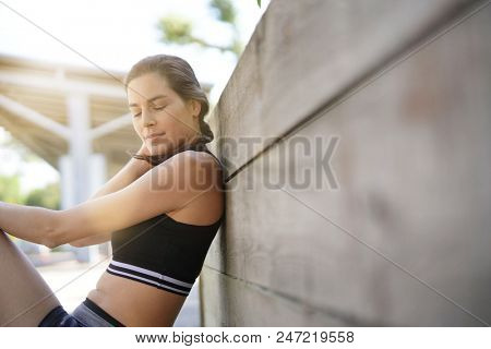 Fitness girl relaxing after exerciing