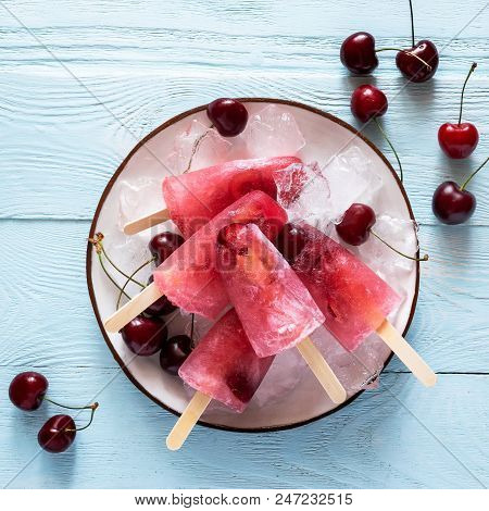 Ice Cream From Ripe Cherries Is Decorated With Fresh Berries, Which Are Served In A White Plate On A