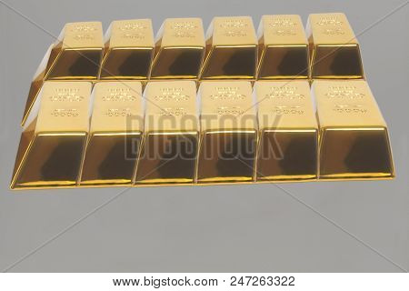 Stacked Bars Of Gold Bullion On A Gray Background.financial Concept