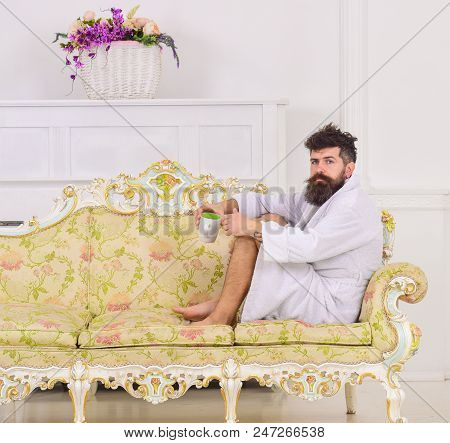 Man With Beard And Mustache Enjoy Morning While Sitting On Old Fashioned Luxury Sofa. Luxury Life Co
