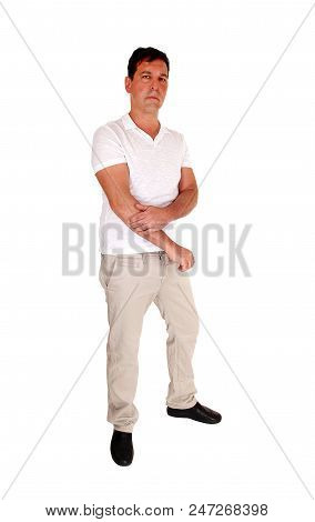 A Tall Handsome Middle Age Man Standing In Beige Slacks And White
T-shirt Looking Serious, Isolated 