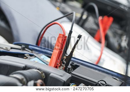 Automobile help. booster jumper cables charging automobile discharged battery