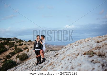 Romantic Summer Love Story On A Sunset In Mountains. Young Girl And Boy In Love.