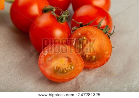 Tomatoes On Baking Paper, Cut In Half