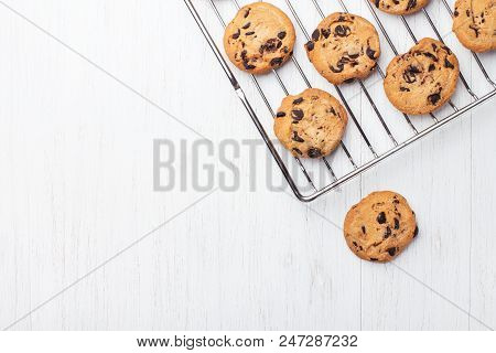 American Cookies With Chocolate Chips On The Grate Fof Oven On White Wooden Background. Top View Wit