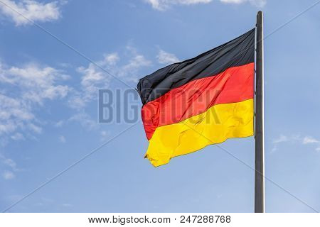 Flag Of Federal Republic Of Germany Waving On The Wind On The Top Of German Parliament Building (bun