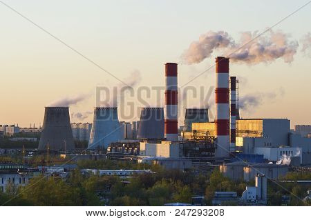 Power Plant Pipes With Swirling Smoke At Sunset, Environmental Pollution, Heavy Industry