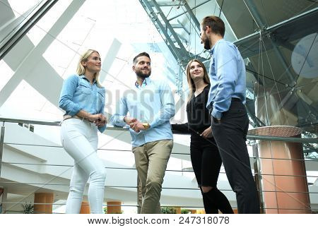 Business Discussion. Modern People In Casual Wear Having A Brainstorm Meeting While Standing In The 