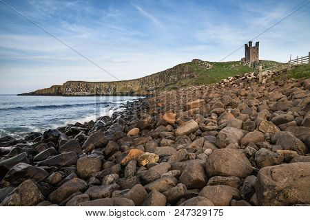 Beautiful Landscape Image Of Dunstanburgh Castle On Northumberland Coastline In England During Late 