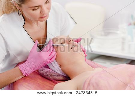 Doctor Making Injecting In Beautiful Face Of Young Woman