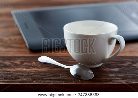 A Cup Of With Spoon In Front Of The Laptop On The Wooden Table, Shallow Depth Of Field, Selctive Foc