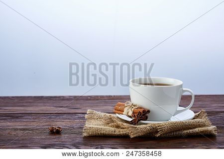 Looking Down On A Cup Of Tea Hot Beverage With Cinnamom, Mint Leaves And Fruits Of Star Anise.