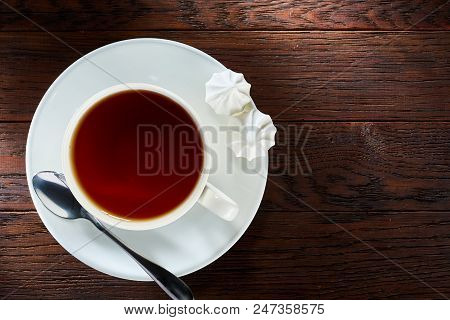 Looking Down On A Cup Of Tea Hot Beverage With Cinnamom, Mint Leaves And Fruits Of Star Anise.