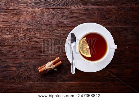Looking Down On A Cup Of Tea Hot Beverage With Cinnamom, Mint Leaves And Fruits Of Star Anise.