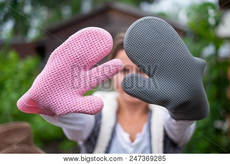 Girl Wearing Speacial Silicone Gloves For Grilling. Safe Cooking Process