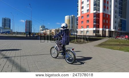 Cute Young Boy Riding Bike In Late Afternoon Sun, View From Back, Healthy Activity Concept. Kid Boy 