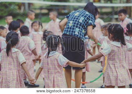 Young Kids Exercise With Hoola Hoop In The Morning.