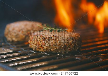 lamb burgers spiced by mint and lamb rub on bbq grill with flame