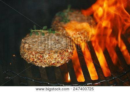 lamb burgers spiced by mint and lamb rub on bbq grill with flame