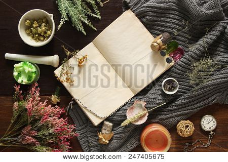 An Open Empty Vintage Notebook Surrounded By Herbs, Alchemy Appliances, Potions And Ingredients Lies
