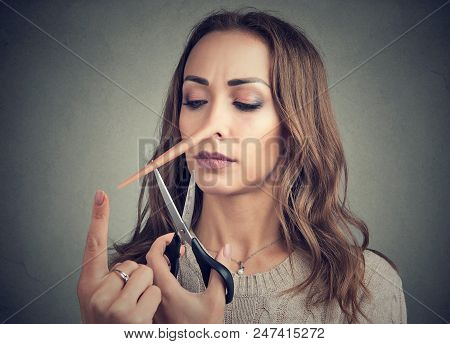 Girl Having Long Nose Of Liar And Trickster Trying To Change And Cut Nose Off With Scissors