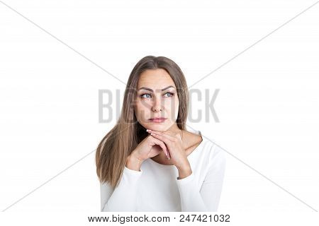 Head And Shoulders Portrait Of A Beautiful Young Woman With Fair Hair Wearing White And Thinking Loo