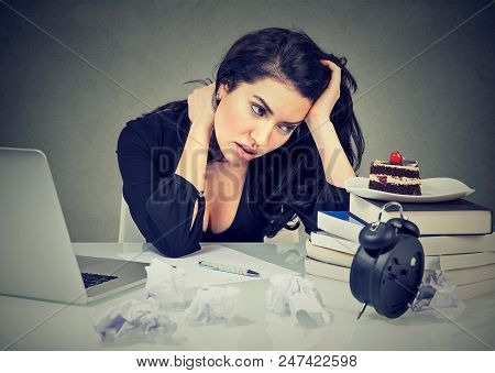 Stressed Woman Sitting At Desk In Her Office Overworked Craving Sweet Cake