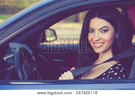 Car Safety Concept. Woman Driver Fastening Seat Belt
