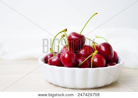 Healthy Eating And Food Concept - Cherries In White Bowl. Cherry On White Background.