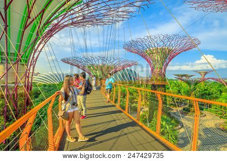 Singapore - April 29, 2018: Asian Tourist Takes Selfie With Smart Phone While Walking On Skybridge O