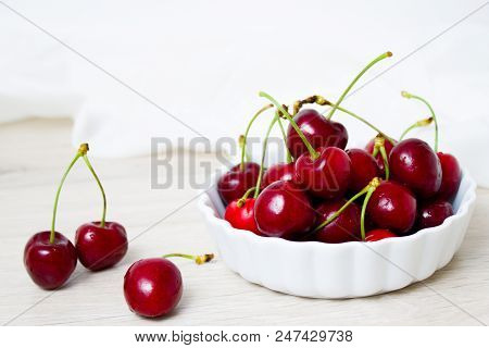 Healthy Eating And Food Concept - Cherries In White Bowl. Cherry On White Background.