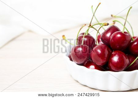 Healthy Eating And Food Concept - Cherries In White Bowl. Cherry On White Background. Copyspace