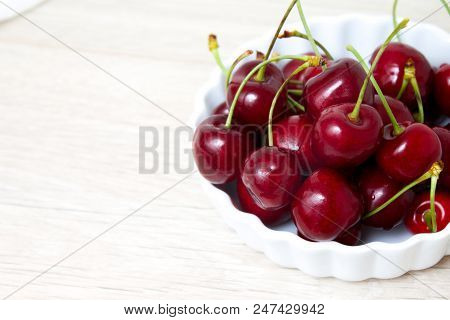 Healthy Eating And Food Concept - Cherries In White Bowl. Cherry On White Background. Copyspace