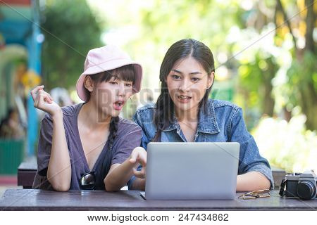 Portrait Of Happy Traveler Woman In City. Asian Women Using Laptop For Seach Location, People With T