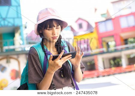 Portrait Of Happy Traveler Woman In City. Asian Women Using Smartphone For Seach Location. Woman Wit