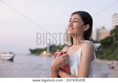 Asain Woman Holding Book At Beach, Woman Holding Book With Attractive Smiling.