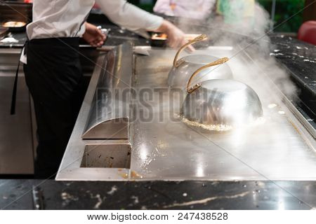 Closed Up Japanese Style Stainless Steel Cooking Dome Lid For Teppanyaki On Hot Stove With Lots Of S