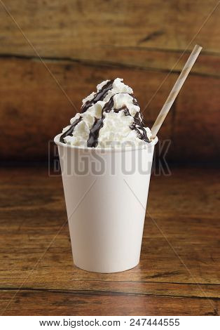 Drink With Whipped Cream On Top In A Disposable Cup On A Wooden Table