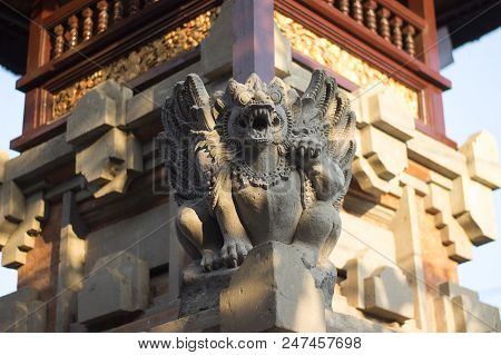 Bali Statue On A Tower In Front Of Temple