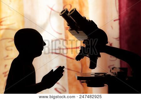 Science Versus Religion. Conceptual Image Analysing Religious Faith And Spirituality. Silhouette Of 